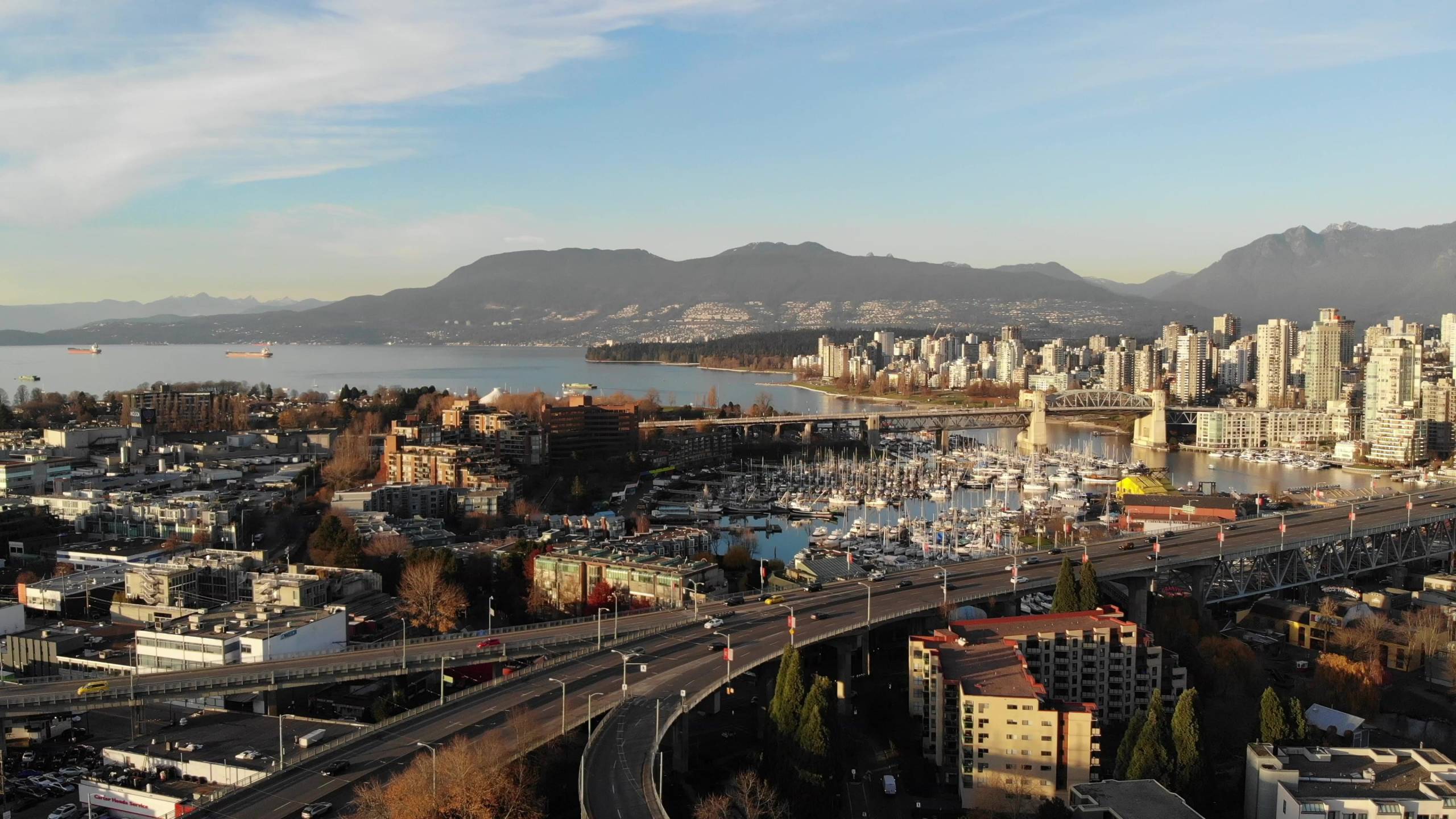 4K aerial view of Granville Island and False Creek Vancouver skyline with Burrard Bridge