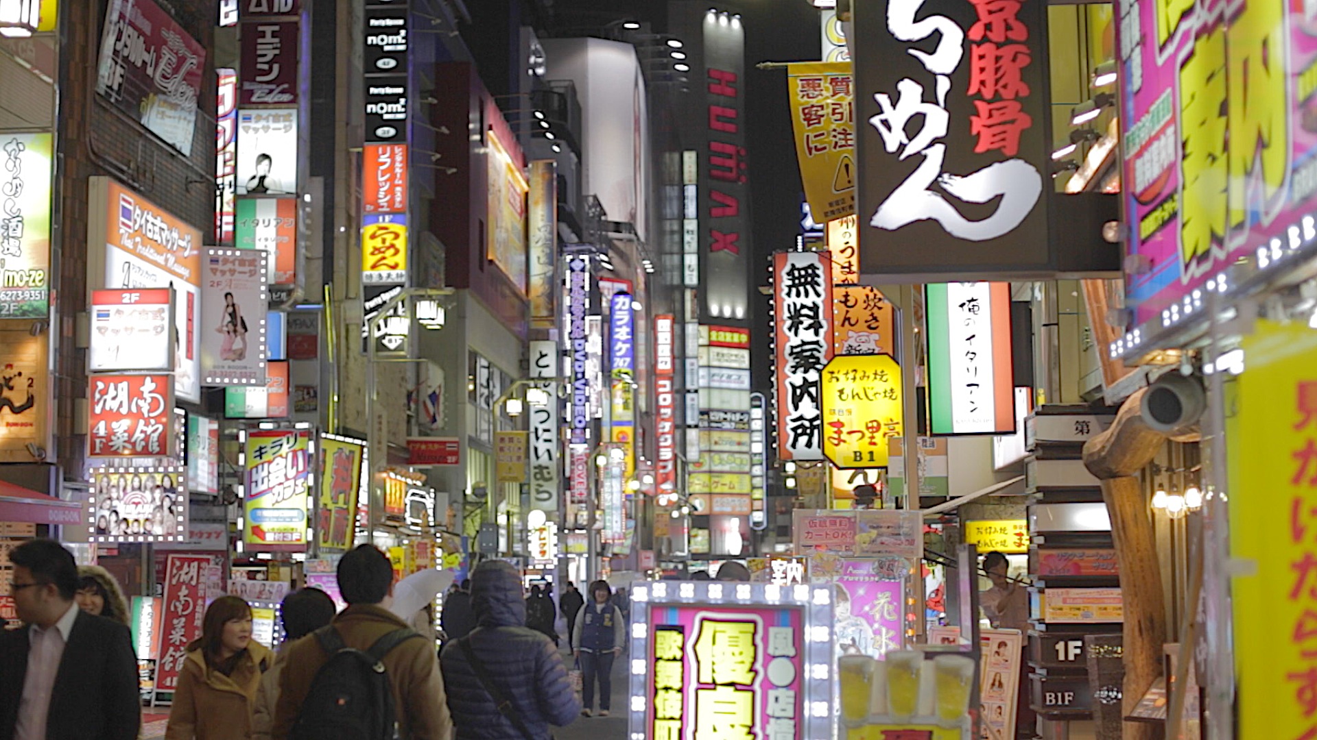 Neon signs on a busy Tokyo street at night